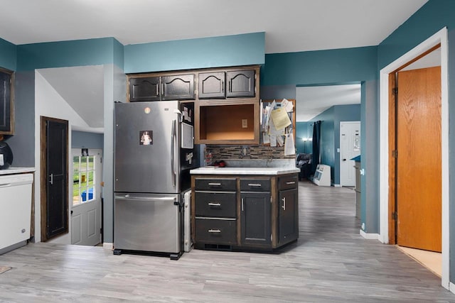 1418 W Washington St, Appleton, WI 54914 - kitchen with freestanding refrigerator, white dishwasher, light wood-style floors, decorative backsplash, and light countertops