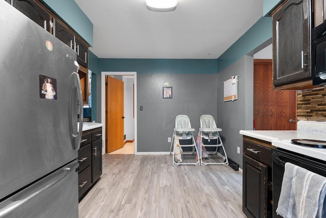 1418 W Washington St, Appleton, WI 54914 - kitchen featuring freestanding refrigerator, light countertops, light wood finished floors, and white range with electric stovetop