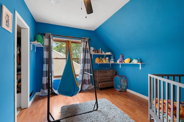1418 W Washington St, Appleton, WI 54914 - bedroom featuring wood finished floors, lofted ceiling, a crib, and ceiling fan
