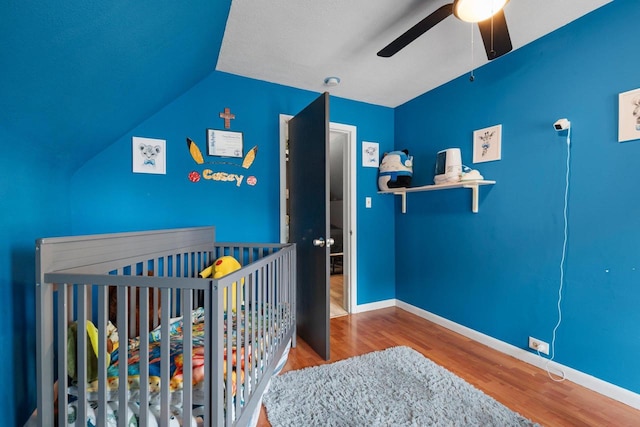 1418 W Washington St, Appleton, WI 54914 - bedroom with wood finished floors, a crib, ceiling fan, and lofted ceiling
