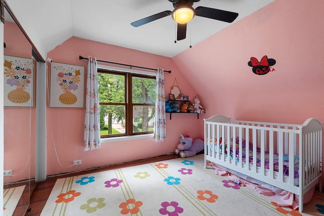 1418 W Washington St, Appleton, WI 54914 - bedroom with lofted ceiling, a crib, wood finished floors, and a ceiling fan