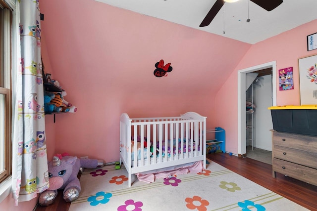 1418 W Washington St, Appleton, WI 54914 - bedroom with vaulted ceiling, wood finished floors, a crib, and ceiling fan