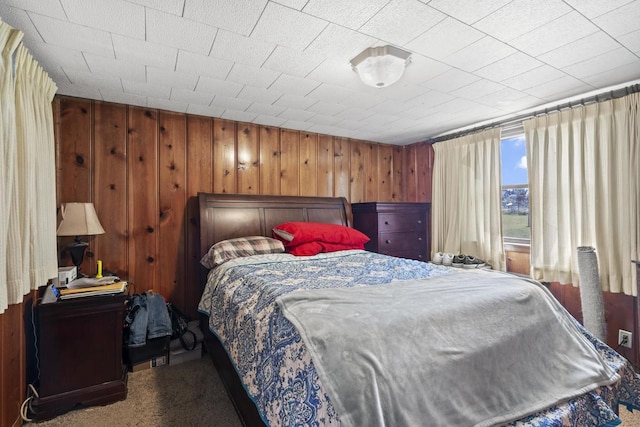 1329 Central St, Oshkosh, WI 54901 - bedroom featuring carpet flooring and wood walls