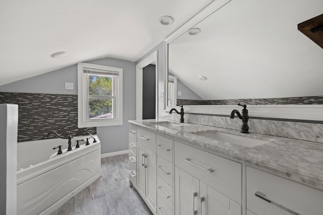 513 61st St, Kenosha, WI 53143 - full bath featuring vaulted ceiling, a garden tub, double vanity, and wood finished floors