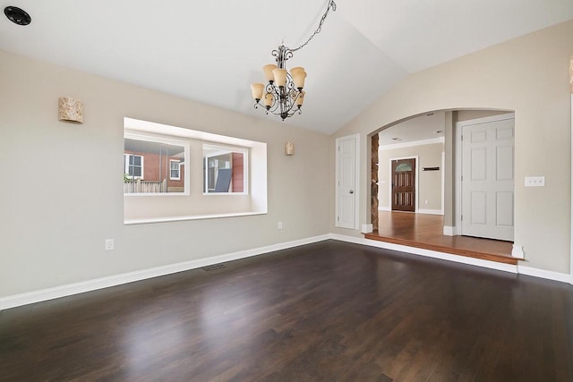 513 61st St, Kenosha, WI 53143 - unfurnished dining area featuring arched walkways, lofted ceiling, a chandelier, and wood finished floors