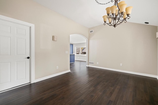 513 61st St, Kenosha, WI 53143 - unfurnished room featuring arched walkways, a chandelier, and dark wood-style flooring