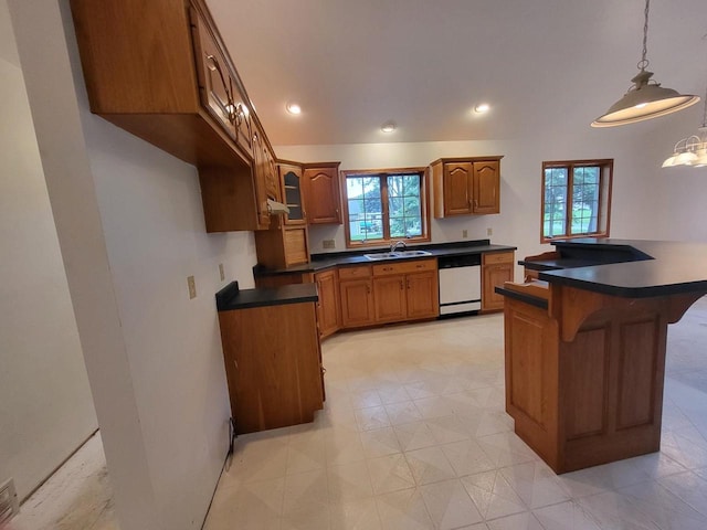 1607 E Cleveland St, Marshfield, WI 54449 - kitchen with white dishwasher, brown cabinetry, a kitchen bar, plenty of natural light, and recessed lighting