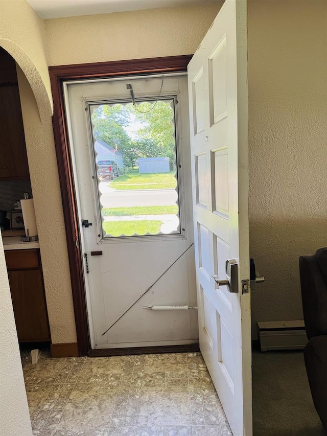 1117 21st St, Monroe, WI 53566 - entryway featuring a baseboard radiator, a textured wall, and arched walkways