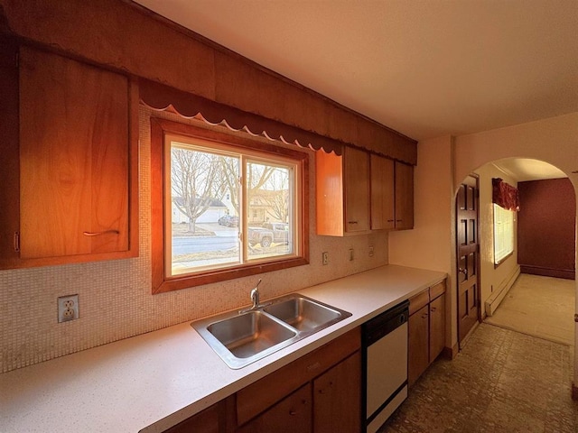 1117 21st St, Monroe, WI 53566 - kitchen featuring dishwasher, arched walkways, light countertops, brown cabinets, and light flooring