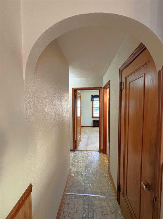 1117 21st St, Monroe, WI 53566 - hallway with arched walkways and a textured wall