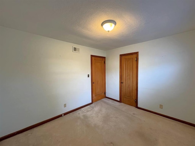 1117 21st St, Monroe, WI 53566 - spare room with a textured ceiling and light carpet