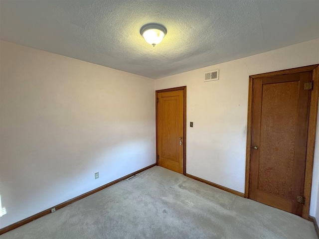 1117 21st St, Monroe, WI 53566 - empty room with light carpet and a textured ceiling