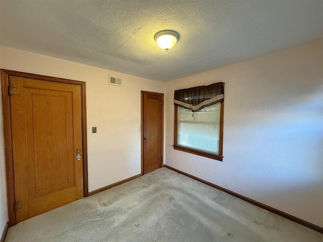 1117 21st St, Monroe, WI 53566 - spare room with light colored carpet and a textured ceiling