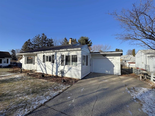 1117 21st St, Monroe, WI 53566 - single story home with concrete driveway, a chimney, and a garage