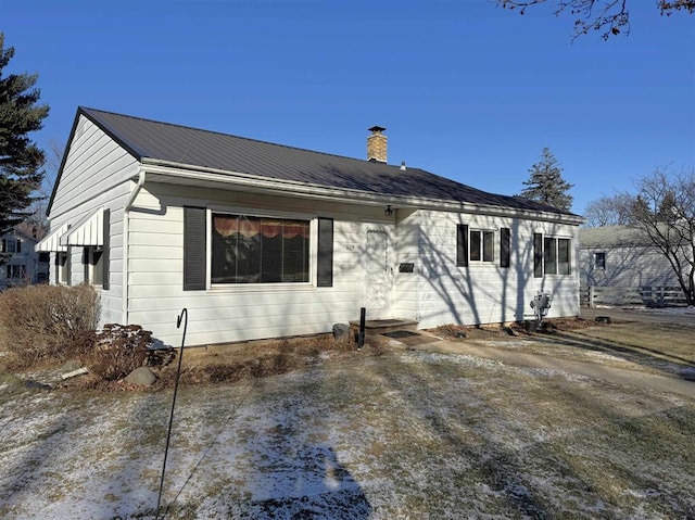 1117 21st St, Monroe, WI 53566 - view of front facade featuring a chimney and a metal roof