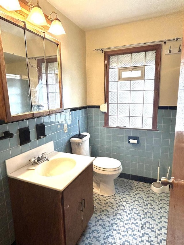 4228 N 52nd St, Milwaukee, WI 53216 - bathroom with tile walls, vanity, a wainscoted wall, plenty of natural light, and tile patterned floors