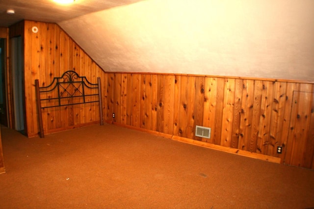 4228 N 52nd St, Milwaukee, WI 53216 - additional living space with vaulted ceiling, wooden walls, and carpet floors