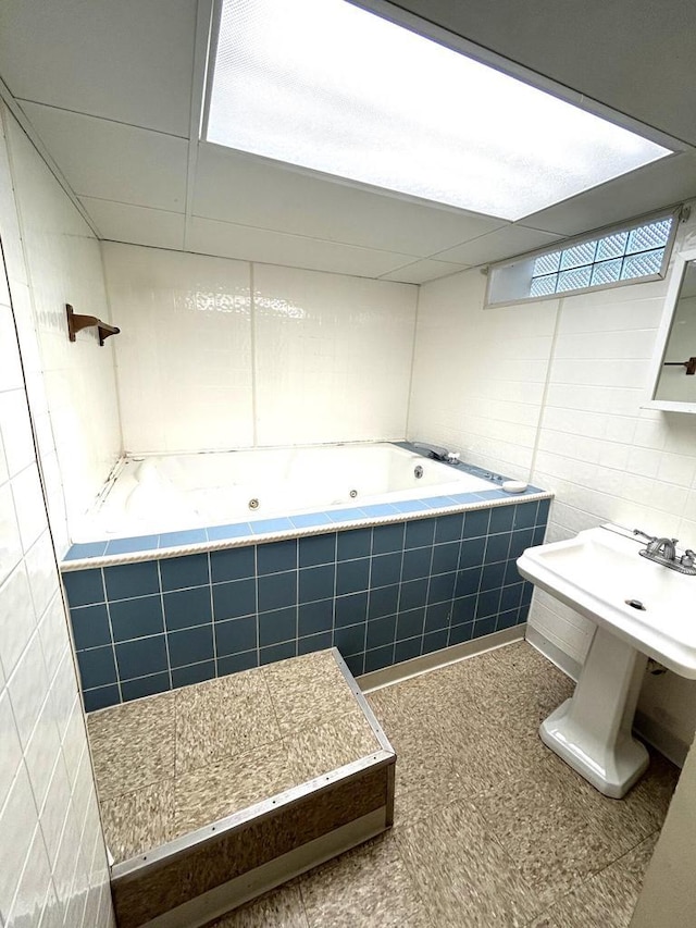 4228 N 52nd St, Milwaukee, WI 53216 - bathroom featuring a jetted tub and tile walls
