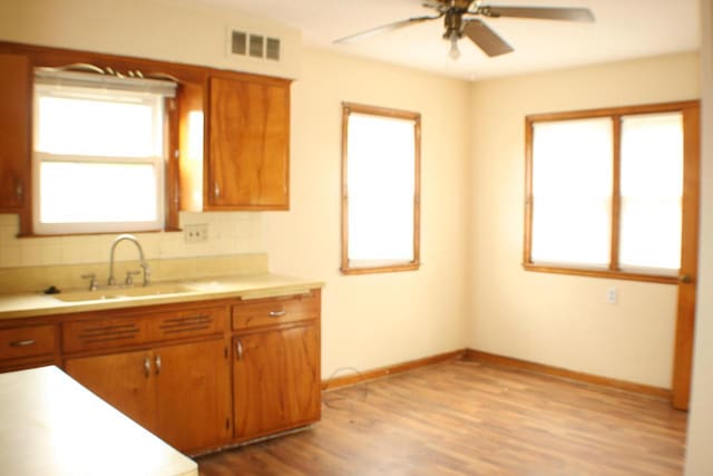 4228 N 52nd St, Milwaukee, WI 53216 - kitchen featuring ceiling fan, light countertops, light wood-type flooring, and brown cabinets