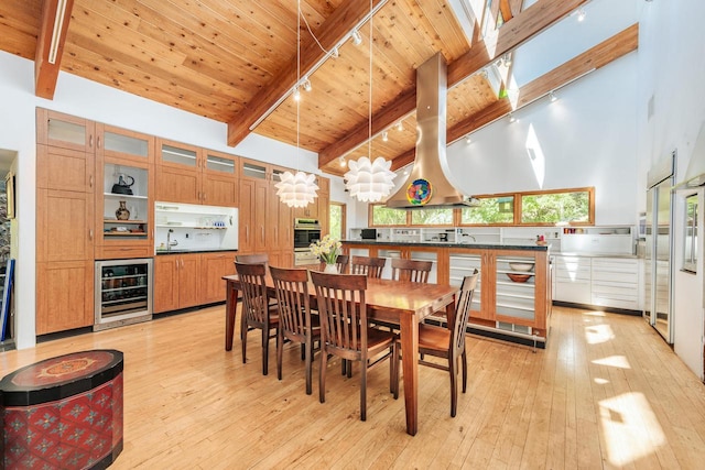 W296N2978 Franciscan Rd, Pewaukee, WI 53072 - dining room featuring beverage cooler, track lighting, light wood-type flooring, high vaulted ceiling, and a wood ceiling with exposed beams
