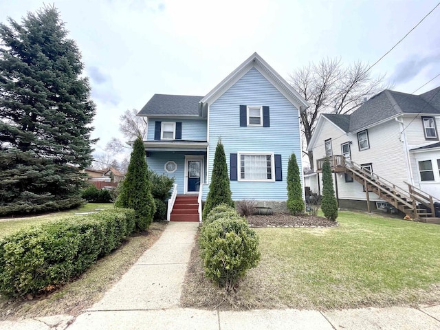 1116 Liberty Ave, Beloit, WI 53511 - view of front of home with stairway and a front lawn