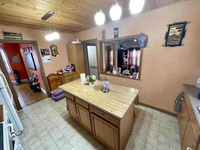 1116 Liberty Ave, Beloit, WI 53511 - kitchen with brown cabinets, wood ceiling, decorative light fixtures, a center island, and freestanding refrigerator