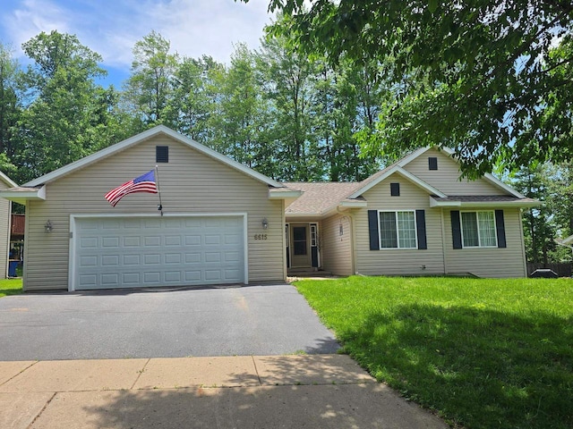 6615 Cavin Dr, Wausau, WI 54401 - single story home featuring a front yard, an attached garage, driveway, and roof with shingles