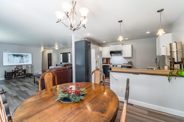 6615 Cavin Dr, Wausau, WI 54401 - dining area with dark wood-style floors, recessed lighting, and a chandelier