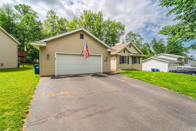 6615 Cavin Dr, Wausau, WI 54401 - single story home featuring asphalt driveway, a front yard, and an attached garage