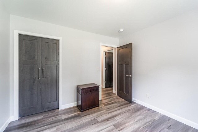 6615 Cavin Dr, Wausau, WI 54401 - unfurnished bedroom featuring light wood-style flooring and a closet