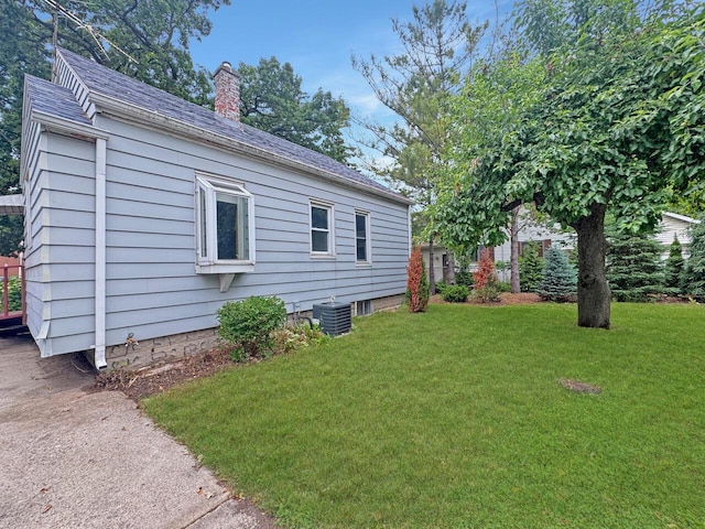 4958 S 20th St, Milwaukee, WI 53221 - view of side of home with a chimney, a lawn, and roof with shingles