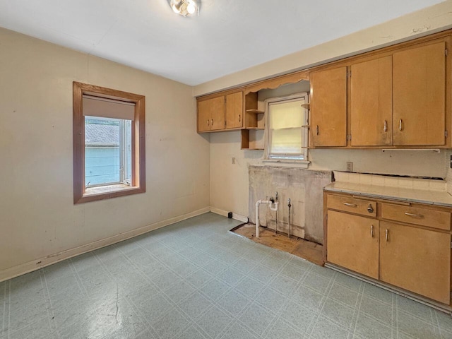 4958 S 20th St, Milwaukee, WI 53221 - kitchen featuring light flooring, light countertops, brown cabinetry, and open shelves