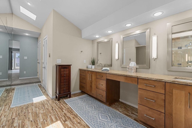 1824 W Reid Dr, Appleton, WI 54914 - bathroom featuring vanity, a skylight, wood finished floors, recessed lighting, and vaulted ceiling