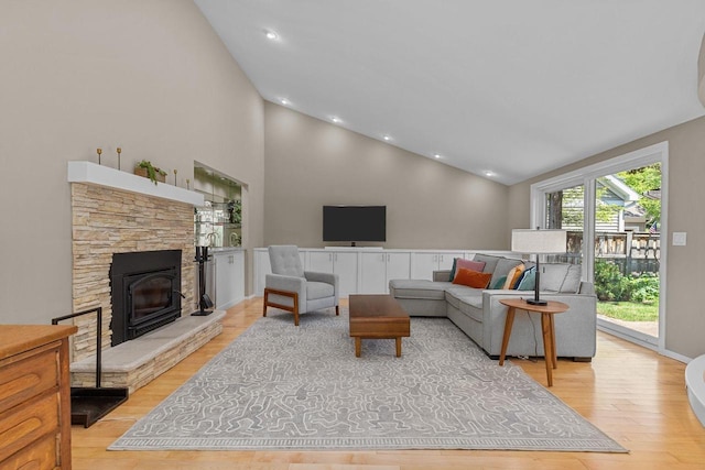 1824 W Reid Dr, Appleton, WI 54914 - living area featuring light wood finished floors, high vaulted ceiling, a stone fireplace, and recessed lighting