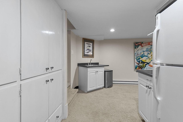1824 W Reid Dr, Appleton, WI 54914 - kitchen with freestanding refrigerator, light colored carpet, dark countertops, recessed lighting, and white cabinets