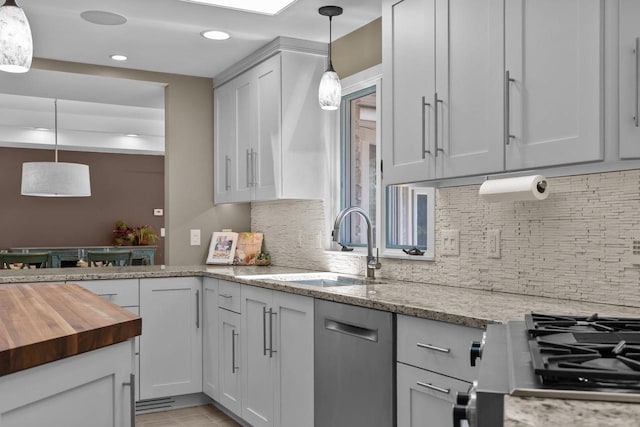1824 W Reid Dr, Appleton, WI 54914 - kitchen with dishwasher, wood counters, decorative backsplash, recessed lighting, and hanging light fixtures