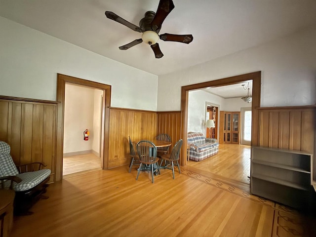 195 E Park Ave, Berlin, WI 54923 - dining area featuring wood finished floors, wainscoting, wooden walls, and a ceiling fan