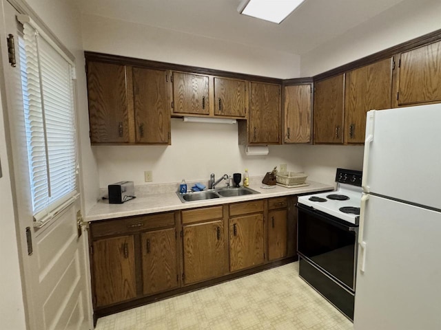 195 E Park Ave, Berlin, WI 54923 - kitchen featuring freestanding refrigerator, range with electric cooktop, light countertops, and light flooring