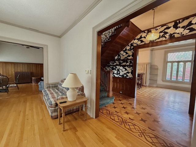 195 E Park Ave, Berlin, WI 54923 - hall with stairway, wood finished floors, wainscoting, vaulted ceiling, and a chandelier