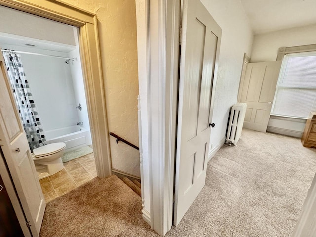 195 E Park Ave, Berlin, WI 54923 - bathroom featuring a textured wall, shower / tub combo with curtain, and radiator heating unit