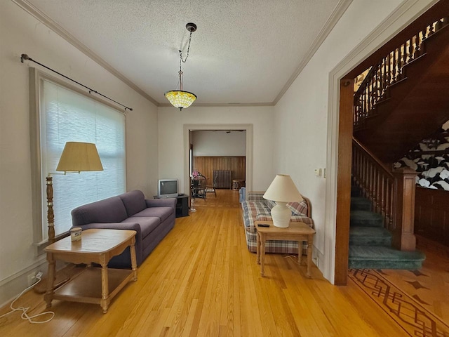 195 E Park Ave, Berlin, WI 54923 - living room featuring stairway, ornamental molding, light wood-type flooring, and a textured ceiling