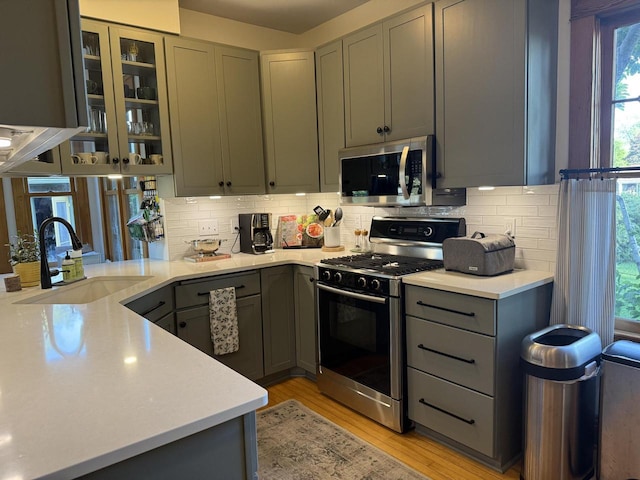 2505 Robinsdale Ave, La Crosse, WI 54601 - kitchen featuring stainless steel appliances, gray cabinets, and backsplash