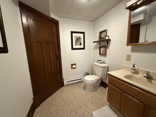 2505 Robinsdale Ave, La Crosse, WI 54601 - half bath featuring a baseboard radiator, a drop ceiling, vanity, and tile patterned flooring