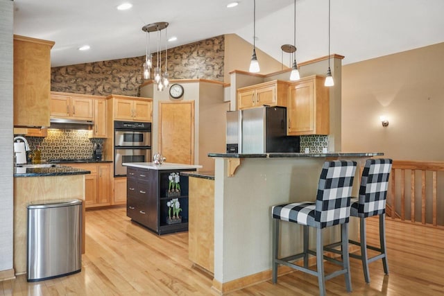 3426 W Links Dr, Franklin, WI 53132 - kitchen with stainless steel appliances, a wainscoted wall, under cabinet range hood, light wood-style flooring, and light brown cabinetry