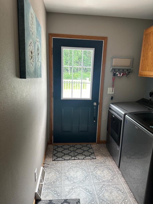 W6767 Pine Ave, Medford, WI 54451 - laundry area with cabinet space, washer and dryer, and light tile patterned floors