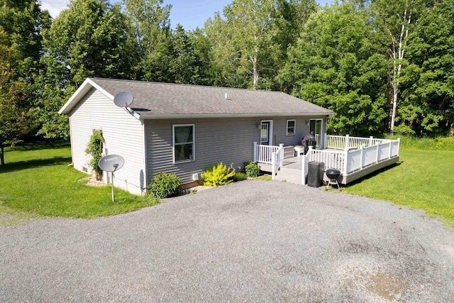 W6767 Pine Ave, Medford, WI 54451 - view of front of house featuring a front yard, a deck, and roof with shingles
