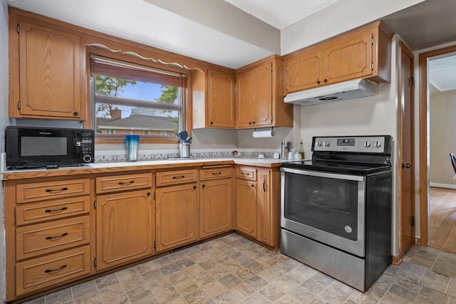 613 Pleasant View St, Wauwatosa, WI 53226 - kitchen featuring stainless steel electric stove, under cabinet range hood, black microwave, stone finish flooring, and light countertops
