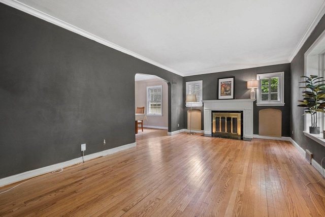 613 Pleasant View St, Wauwatosa, WI 53226 - unfurnished living room featuring arched walkways, wood finished floors, a fireplace with flush hearth, and crown molding