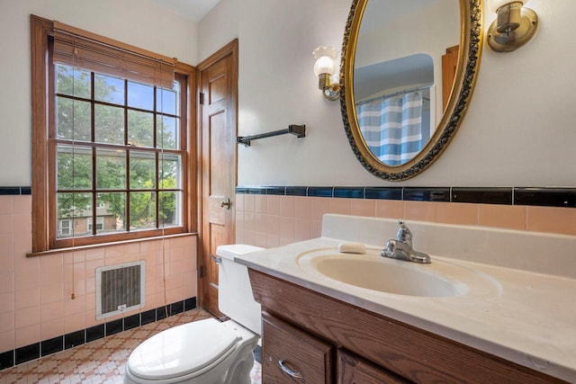 613 Pleasant View St, Wauwatosa, WI 53226 - full bathroom featuring tile walls, vanity, wainscoting, and heating unit