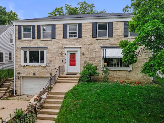 613 Pleasant View St, Wauwatosa, WI 53226 - colonial-style house with an attached garage, stone siding, and a front yard
